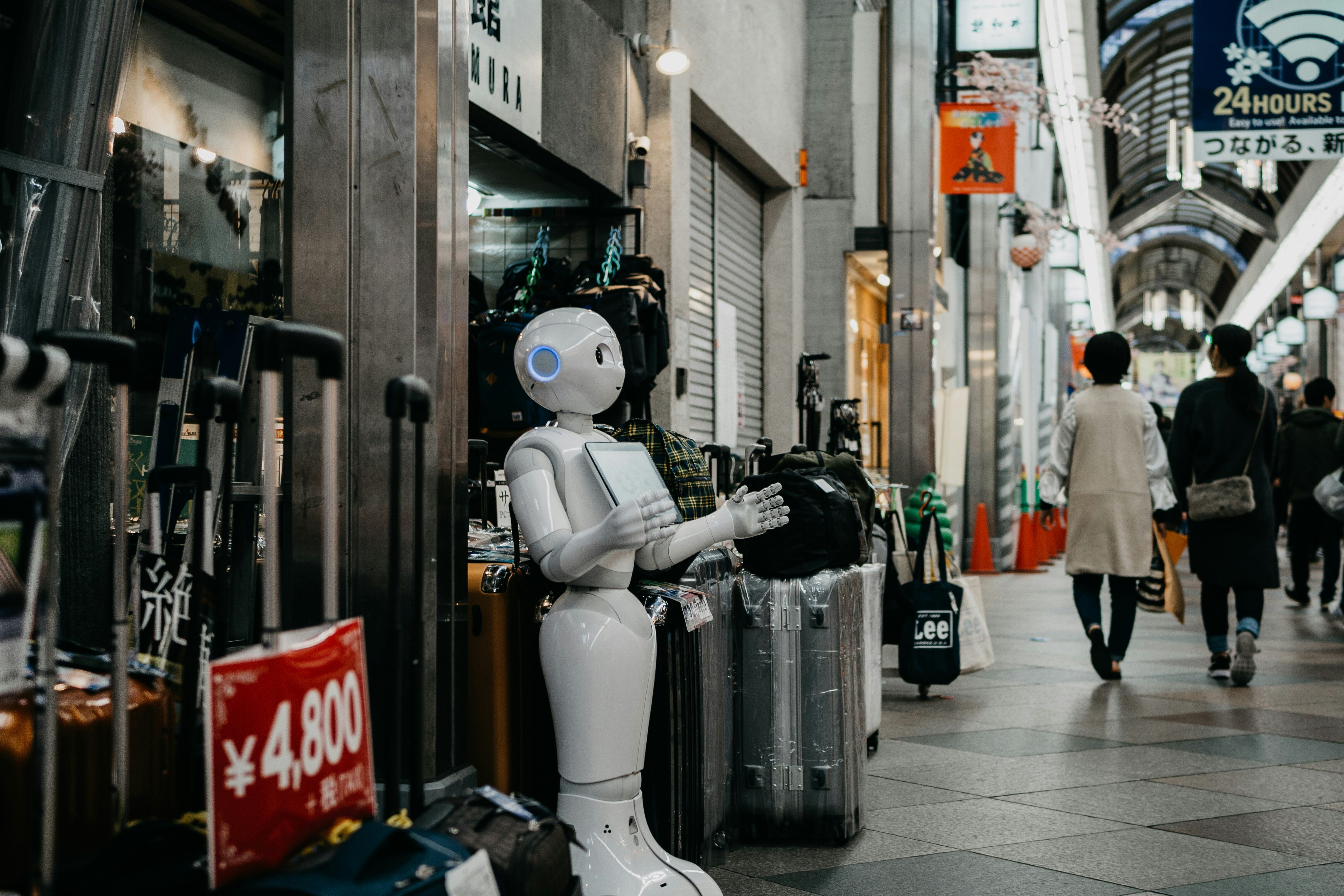 A white robot stands in a shopping mall in Kyoto